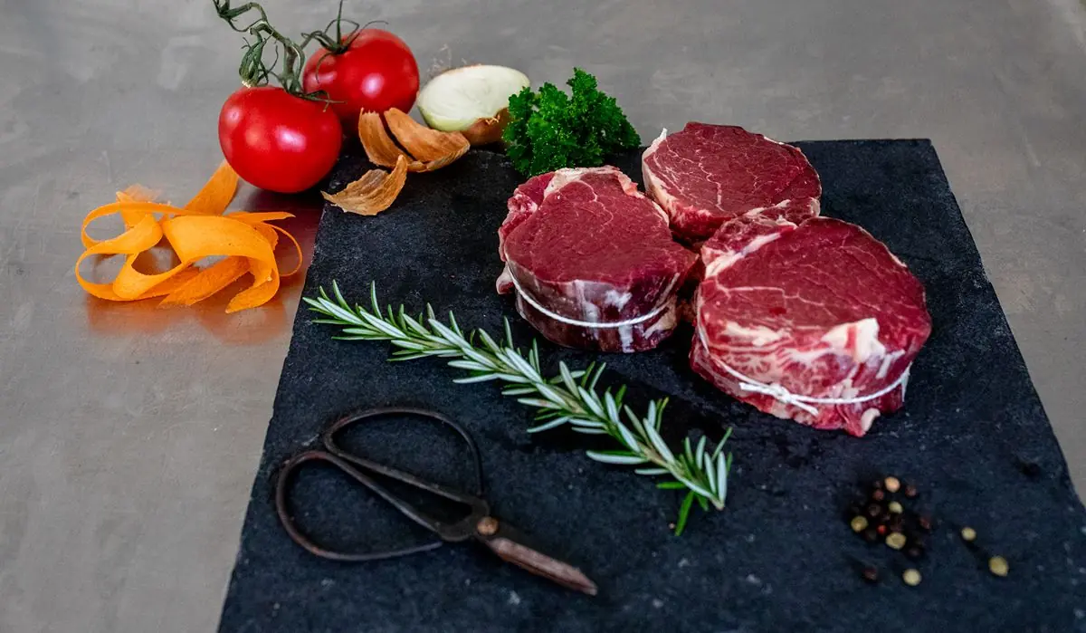 A product photograph of Tamar Beef displayed with vegetables and other ingredients.
